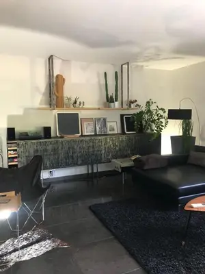 a living room with a couch and a tv at Menerbes Luberon maison moderne clim piscine in Ménerbes