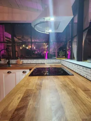 a kitchen with a wooden floor and a large window at L'Apt Tropez in Apt