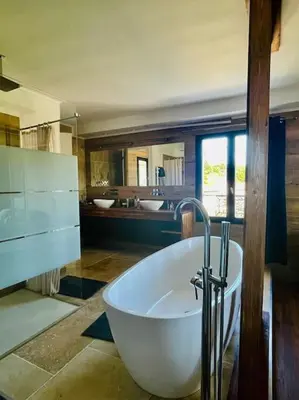 a large bathroom with a tub and two sinks at L'Apt Tropez in Apt