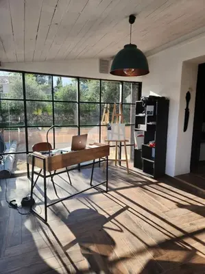 a room with a table with a laptop on it at L'Apt Tropez in Apt
