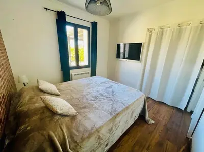 a bedroom with a bed with two pillows on it at L'Apt Tropez in Apt