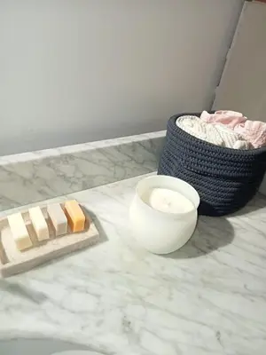 a block of cheese and a bowl on a counter at petite maison avec jardin calme in Le Thor