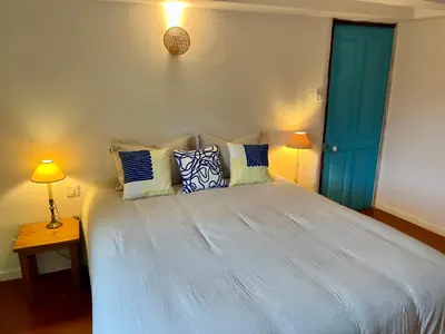 a bedroom with a bed with blue doors and pillows at Charming & medieval village house completely renovated with great exterior and views in Mallemort