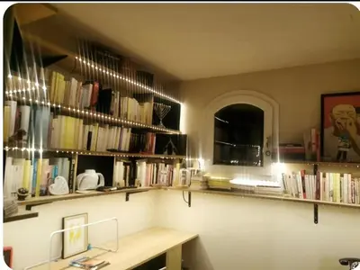 a room with shelves of books on the wall at Là où le Ciel est né Beau mas pierres et contemporain sur grande propriété vue Mont Ventoux dentelles de Montmirail in Blauvac