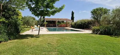 a swimming pool in a yard with a gazebo at La Bastide des Muriers in Gargas