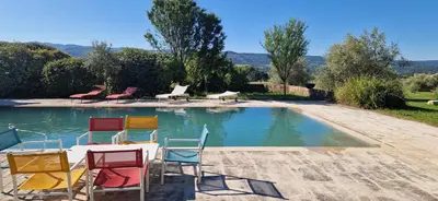 a group of chairs sitting next to a swimming pool at La Bastide des Muriers in Gargas