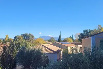 a view of a town with houses and trees at Maison provençale avec piscine partagée in Loriol-du-Comtat