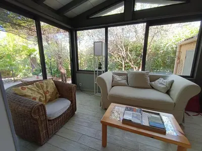 a living room with two couches and a coffee table at Maison provençale avec piscine partagée in Loriol-du-Comtat