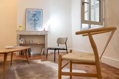 a living room with a chair and a table at Mistral126 in Aix-en-Provence
