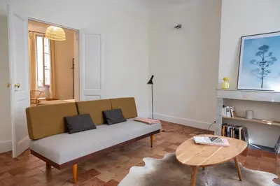 a living room with a couch and a table at Mistral126 in Aix-en-Provence