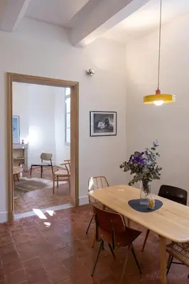 a dining room with a wooden table and chairs at Mistral126 in Aix-en-Provence