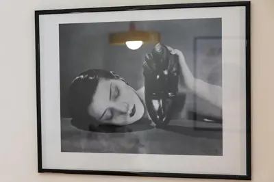 a black and white photo of a woman holding a shoe at Mistral126 in Aix-en-Provence