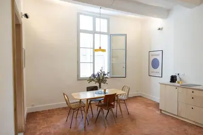 a dining room with a table and chairs at Mistral126 in Aix-en-Provence