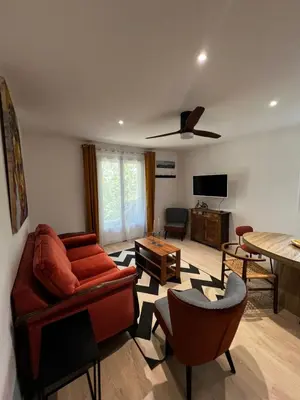 a living room with a couch and a table at Gîte de charme pour 6 personnes à Apt in Apt