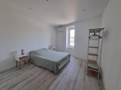 a bedroom with a bed and a book shelf at Maison de village avec terrasse in Grans