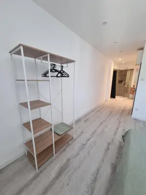 a white book shelf in a white room at Maison de village avec terrasse in Grans