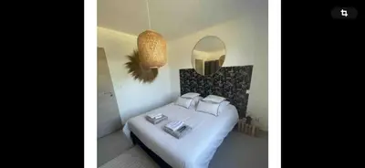 two pictures of a bedroom with a bed and a mirror at Le jardin de Vaumartin in Meyrargues