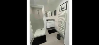 a white bathroom with a shower and a sink at Le jardin de Vaumartin in Meyrargues