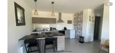 a kitchen with an island in the middle of a room at Le jardin de Vaumartin in Meyrargues