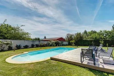 a swimming pool in a yard with two chairs next to it at Les Hauts de Provence - Maison avec piscine in Aix-en-Provence