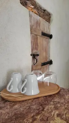 a tray with two cups and glasses on a table at Mas la Floreline in Cheval-Blanc