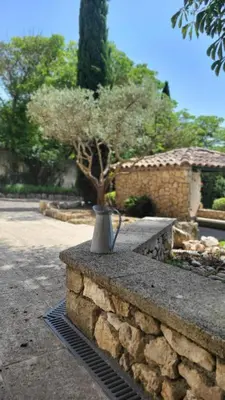 a vase sitting on top of a stone wall at Mas la Floreline in Cheval-Blanc