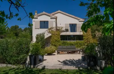 a house with a bench in front of it at Maison familiale avec piscine in Aix-en-Provence