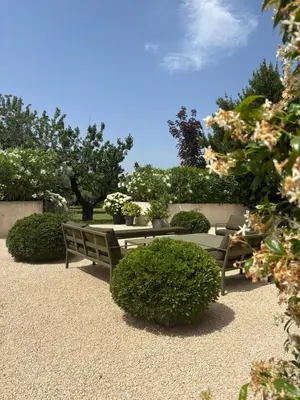 a park with two benches and some bushes and trees at Maison familiale avec piscine in Aix-en-Provence