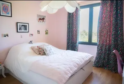 a bedroom with a bed and a window at Maison familiale avec piscine in Aix-en-Provence