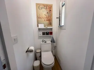 a small bathroom with a toilet and a picture on the wall at Mazet des Balestiés cœur Luberon 120 m2 6 pers avec piscine in Gargas