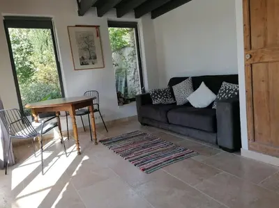 a living room with a couch and a table at Le Mazet d'Alexis in Maubec