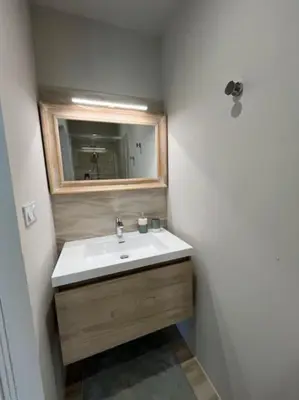 a bathroom with a sink and a mirror at Belle contemporaine avec piscine proche d'Aix en Provence in Rognes