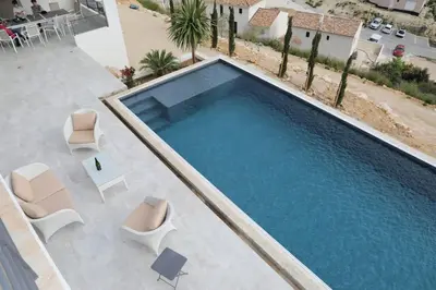 an overhead view of a swimming pool with chairs at Belle contemporaine avec piscine proche d'Aix en Provence in Rognes