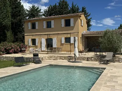 a house with a swimming pool in front of a house at Air-conditioned villa with private pool overlooking Roussillon - Luberon - 8 people. in Roussillon