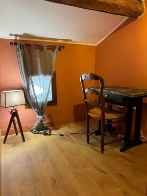 a room with a desk and a chair and a lamp at Maison Jasmin in the city center with parking space and terrace in LʼIsle-sur-la-Sorgue