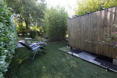 a backyard with a table and chairs and a fence at Studio dans le Luberon in Céreste