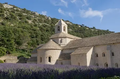 a church with purple flowers in front of it at Studio dans le Luberon in Céreste