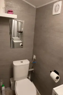 a bathroom with a white toilet and a mirror at Studio dans le Luberon in Céreste