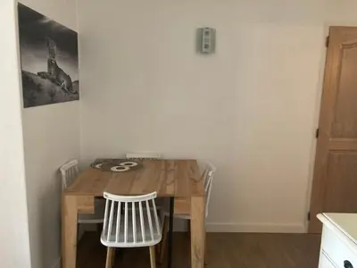 a wooden table and chairs in a room at appartement T3 golf in Mallemort