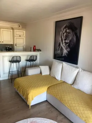 a bedroom with a bed with a lion picture on the wall at appartement T3 golf in Mallemort