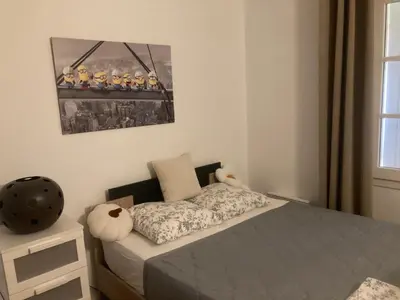 a bedroom with a bed and a picture on the wall at appartement T3 golf in Mallemort