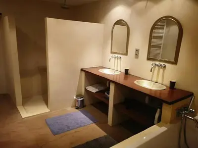 a bathroom with two sinks and a tub at Bergerie de charme proche Aix en Provence et Lubéron in Rognes