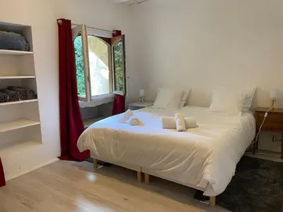 a bedroom with a bed with two pillows on it at Bergerie de charme proche Aix en Provence et Lubéron in Rognes