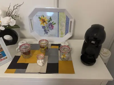 a table with a coffee maker and glasses on it at Chambre chez habitant résidence piscine in Carpentras