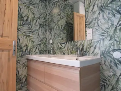 a bathroom with a sink and a leafy wallpaper at Maison face au Luberon avec piscine - 5 Chambres in Cabrières-dʼAvignon