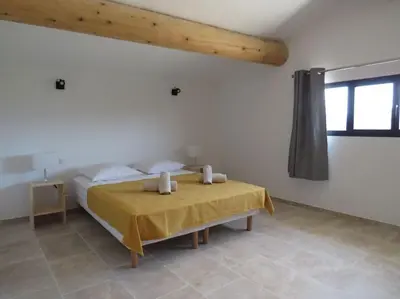 a bedroom with a bed with two candles on it at Maison face au Luberon avec piscine - 5 Chambres in Cabrières-dʼAvignon