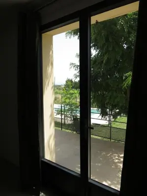 a window with a view of a patio outside at Maison face au Luberon avec piscine - 5 Chambres in Cabrières-dʼAvignon