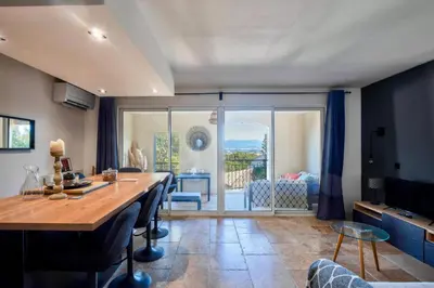 a dining room with a table and a room with a balcony at Village Pont Royal en Provence - maeva Home - Appartement moderne et climatisé 2 pièces 4 personnes - Prestige - super Home MAE-0581 in Mallemort