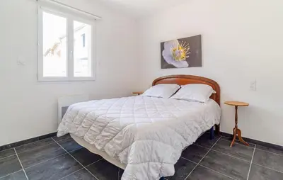 a bedroom with a bed and a window at 2 Bedroom Nice Home In Chateaurenard in Châteaurenard