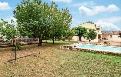 a goal in a yard next to a swimming pool at Amazing Home In Beaumont-De-Pertuis in Beaumont-de-Pertuis